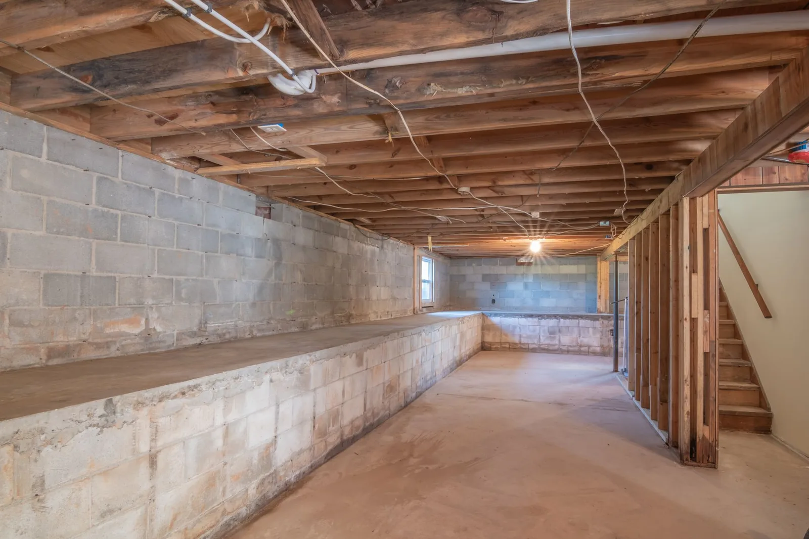 Basement stud framing against a block wall